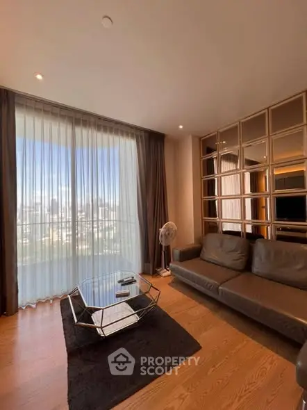 Spacious living room with modern decor and stunning city view through large windows.
