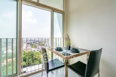 Charming balcony dining area with city view, perfect for intimate meals and relaxation.
