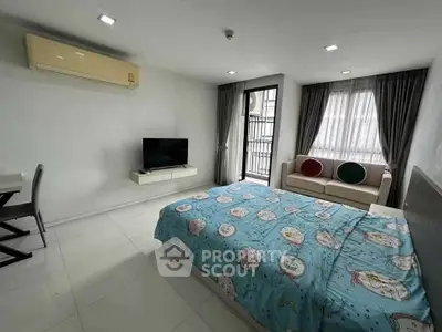 Spacious bedroom with modern decor and natural light, featuring a cozy bed and stylish furniture.