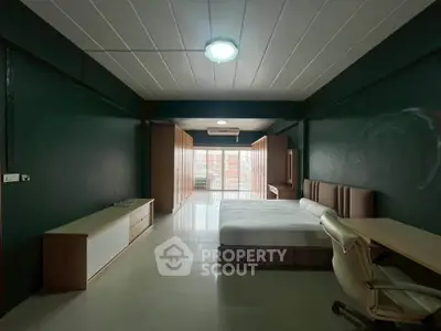 Spacious modern bedroom with minimalist design and ample natural light