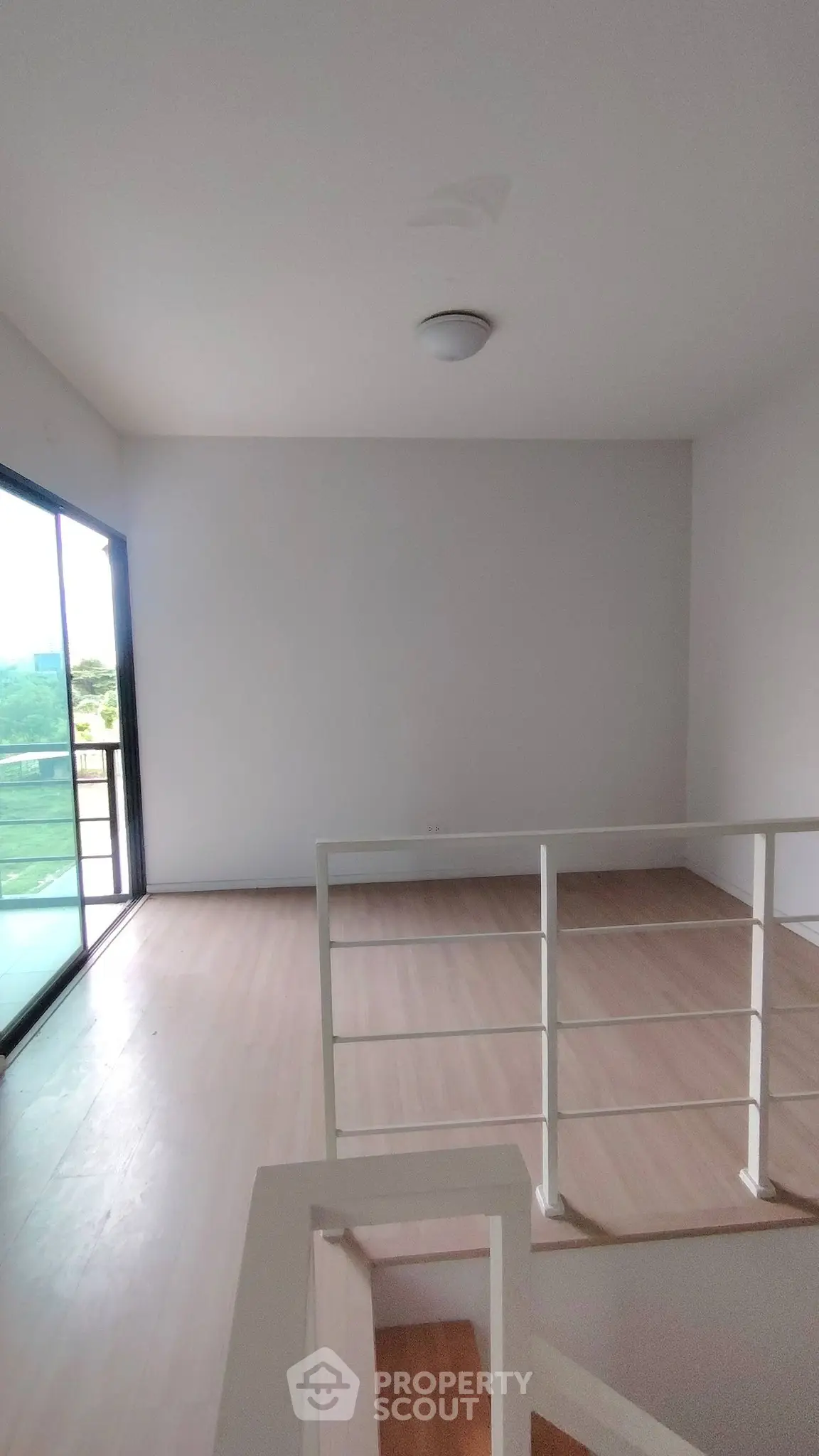 Spacious modern living area with natural light and balcony access, perfect for relaxation and entertaining.