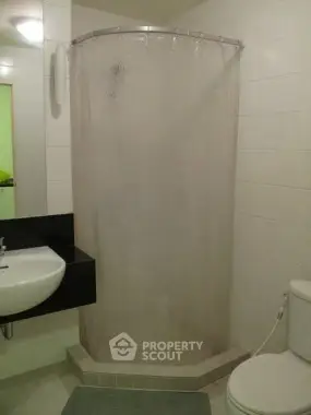 Modern bathroom with corner shower and sleek sink design