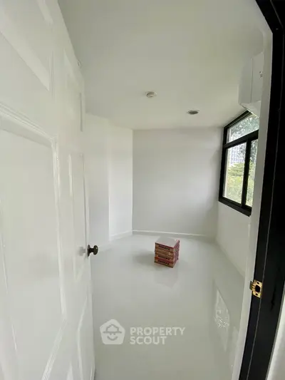 Minimalist empty room with large window and glossy white floor, ideal for customization.
