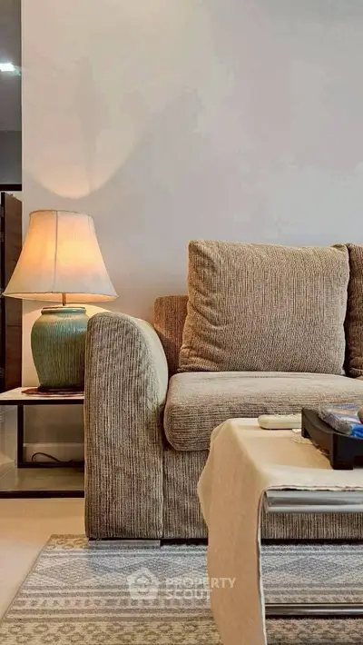 Elegant living room with cozy sofa and stylish lamp, perfect for relaxation and comfort.