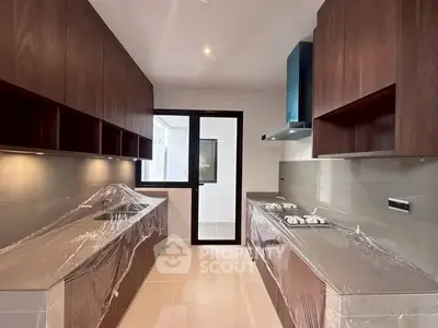 Modern kitchen with sleek cabinetry and gas stove, perfect for culinary enthusiasts.