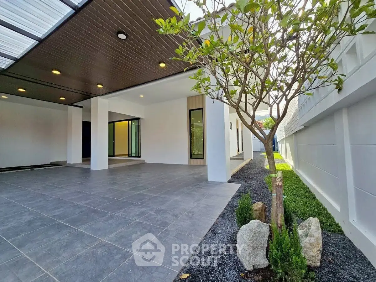 Modern home exterior with spacious covered patio and landscaped garden.