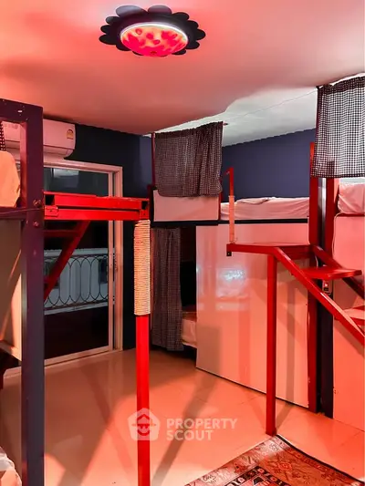 Modern shared bedroom with bunk beds and unique lighting, ideal for co-living spaces.