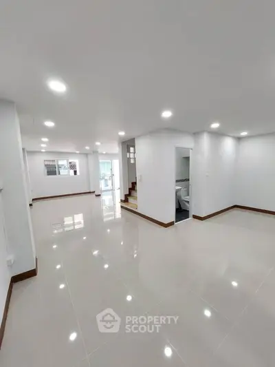 Spacious modern interior with glossy tile flooring and bright lighting