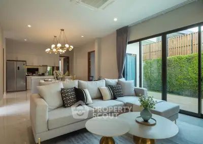 Luxurious open-plan living room with elegant decor and garden view