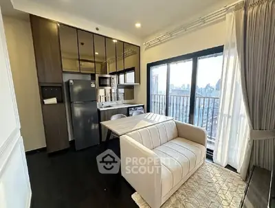 Modern apartment living room with kitchenette and city view balcony.