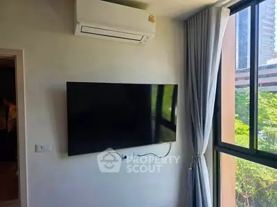 Modern living room with wall-mounted TV and large window view