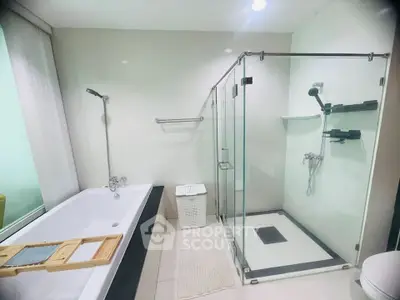 Luxurious modern bathroom with glass shower and bathtub in elegant real estate property.