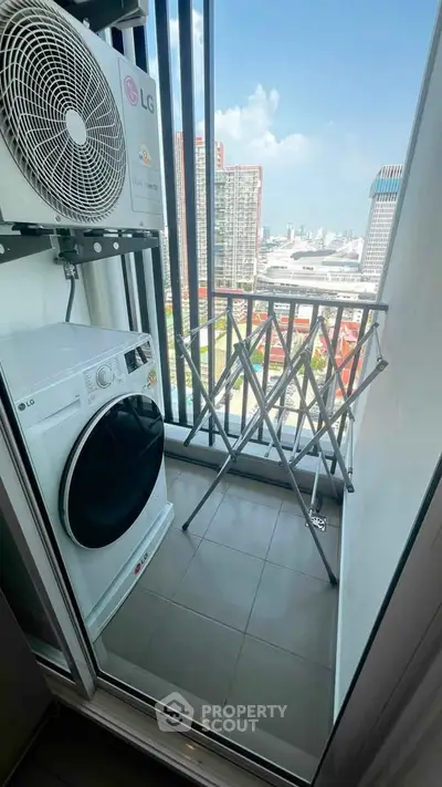 Compact balcony with laundry appliances and city view