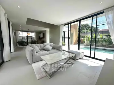 Modern living room with pool view and elegant furnishings