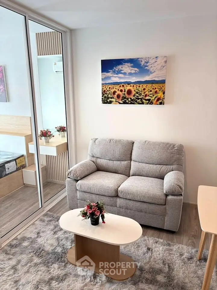 Cozy living room with plush sofa, modern decor, and vibrant sunflower artwork, perfect for relaxation.