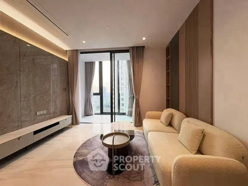 Modern living room with elegant decor and city view balcony access.