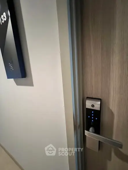 Modern apartment door with electronic lock and room number 193, showcasing secure living.