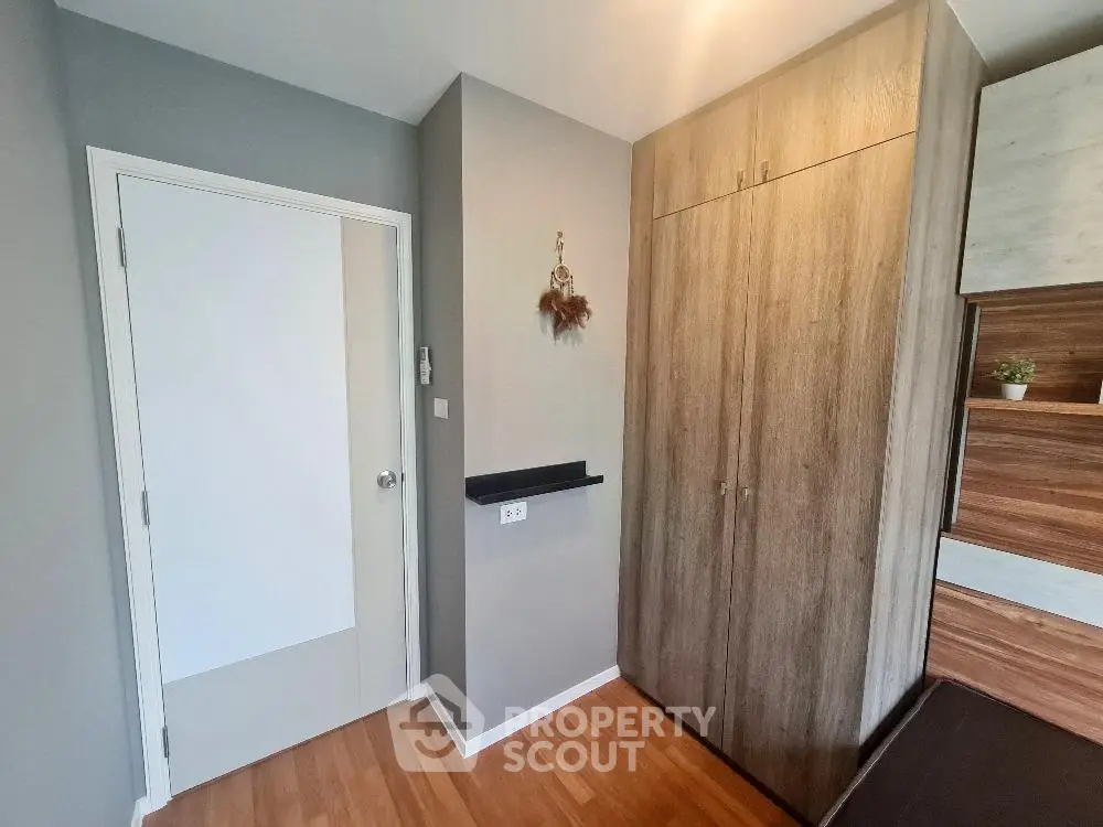 Modern bedroom with wooden flooring and built-in wardrobe
