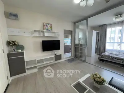 Modern living room with TV and sliding doors to bedroom, bright and stylish.