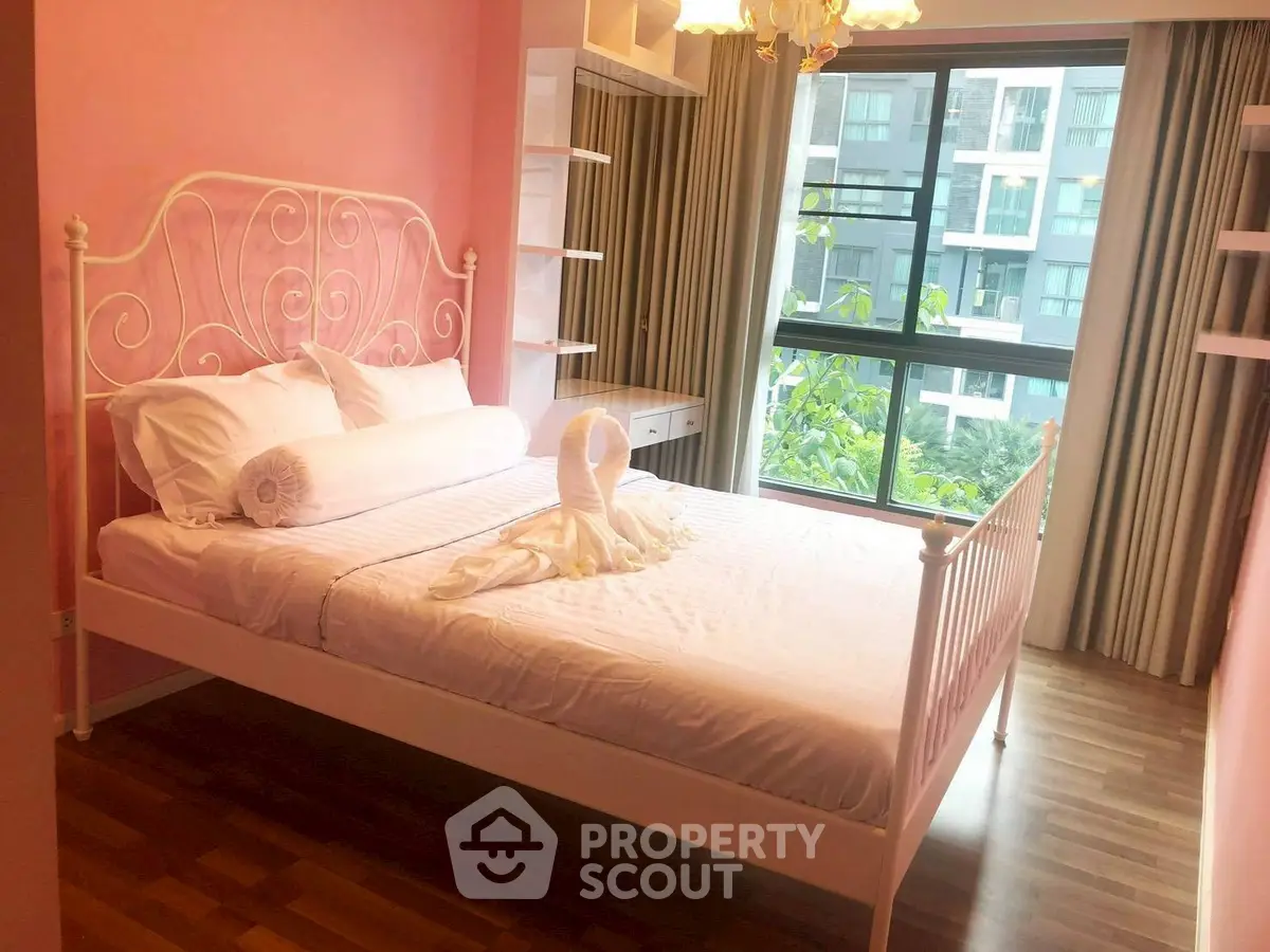 Charming bedroom with elegant bed and large window view in modern apartment.