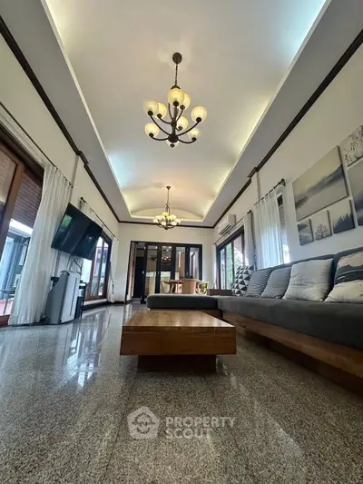 Luxurious living room with elegant chandeliers and spacious seating area