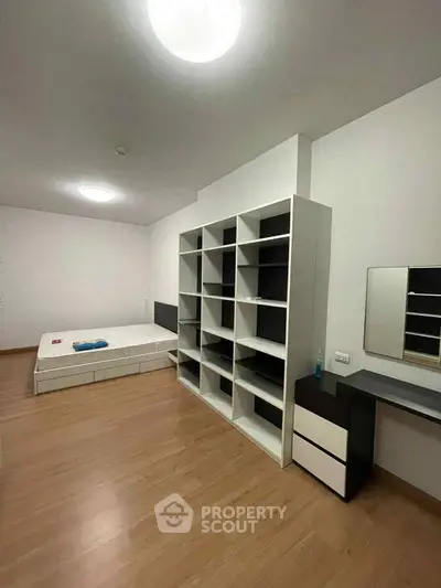 Spacious bedroom with modern shelving and minimalist decor