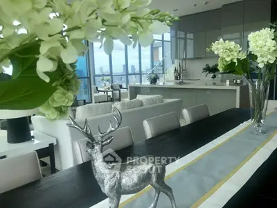 Luxurious open-plan living room with stunning city views and elegant decor.
