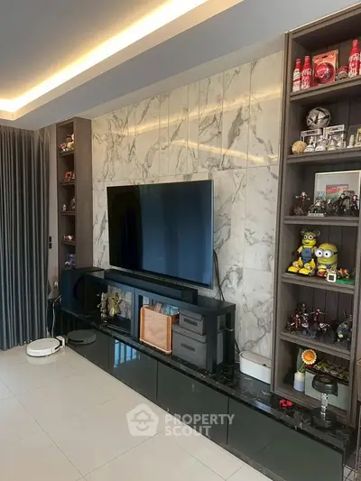Modern living room with sleek TV setup and marble accent wall