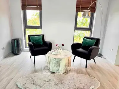 Chic modern living room with stylish armchairs and natural light