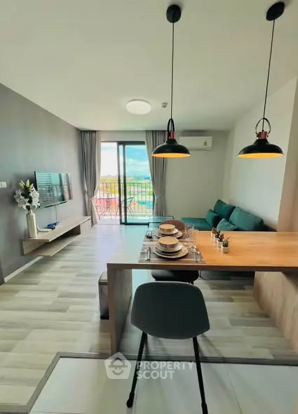 Modern living room with dining area and balcony view in stylish apartment