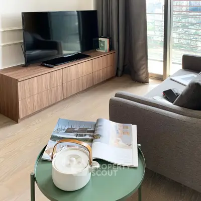 Modern living room with sleek TV stand, cozy sofa, and stylish decor, perfect for relaxation and entertainment.