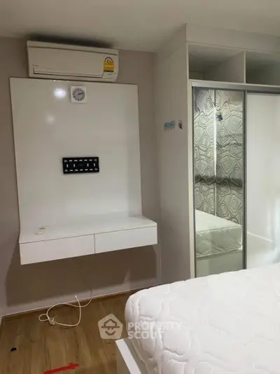 Modern bedroom with built-in closet and air conditioning unit