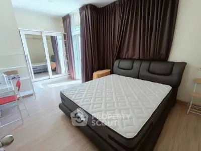 Spacious bedroom with modern design and large windows for natural light