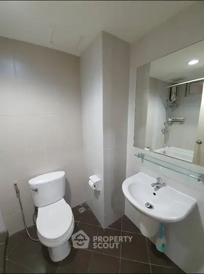 Modern bathroom with sleek fixtures and neutral tiles