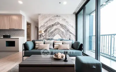 Modern living room with stylish decor and large windows offering city views