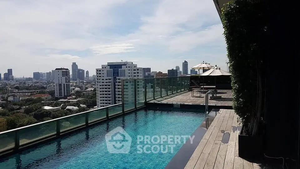 Luxurious rooftop pool with stunning city skyline views in modern urban setting.