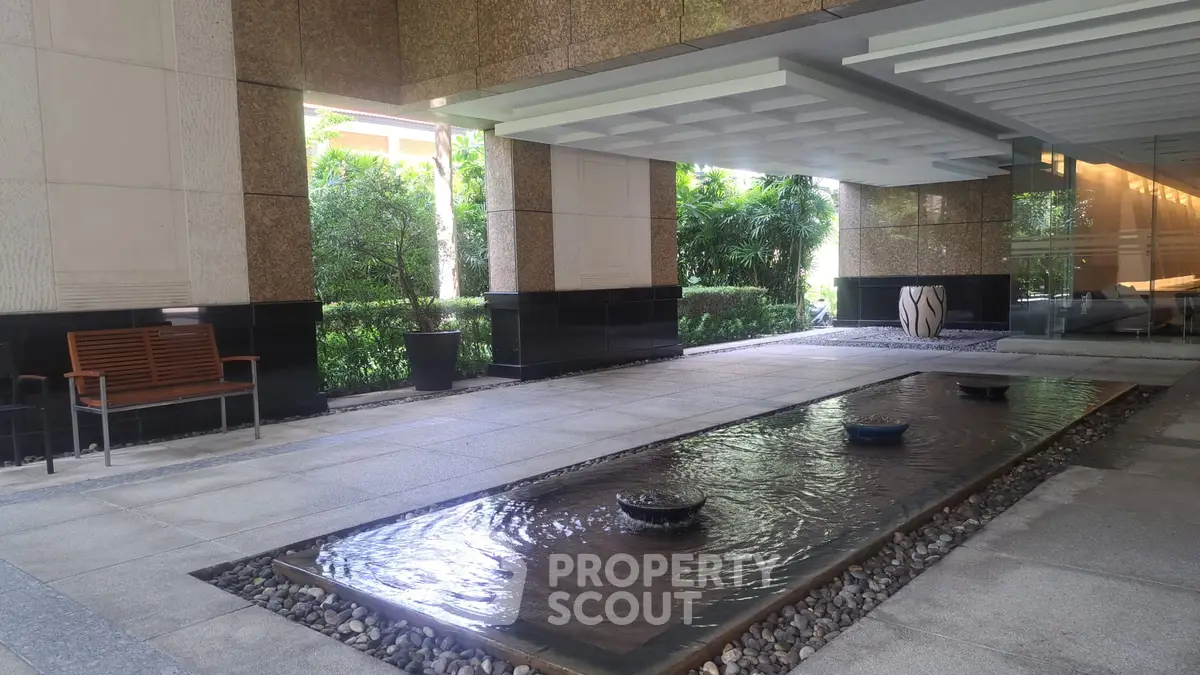 Luxurious building entrance with elegant water feature and modern design