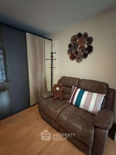 Cozy living room with leather sofa and stylish wall decor