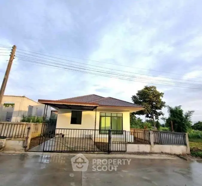 Charming single-story house with gated entrance and spacious yard, perfect for family living.