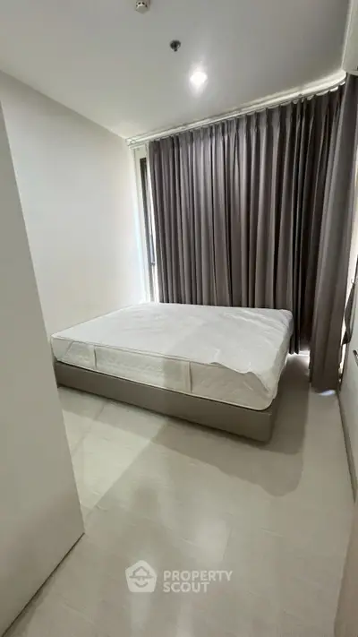 Cozy bedroom with minimalist design and large window for natural light