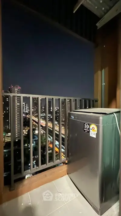 Charming balcony with city skyline view and modern washing machine, perfect for urban living.