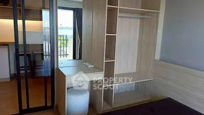 Modern bedroom with built-in storage and balcony view