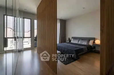 Modern bedroom with wooden partition and large windows in stylish apartment