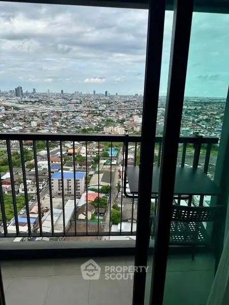 Stunning high-rise balcony view overlooking cityscape with expansive skyline.