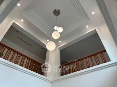Elegant modern interior with high ceiling and stylish lighting fixture