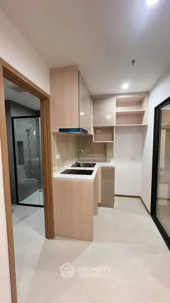 Modern kitchen with sleek cabinetry and open layout in a contemporary apartment.