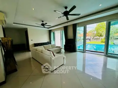 Spacious living room with pool view and modern decor