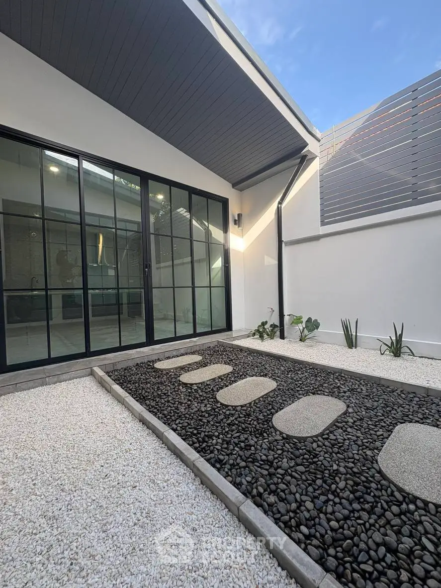 Modern minimalist courtyard with sleek design and stone pathway