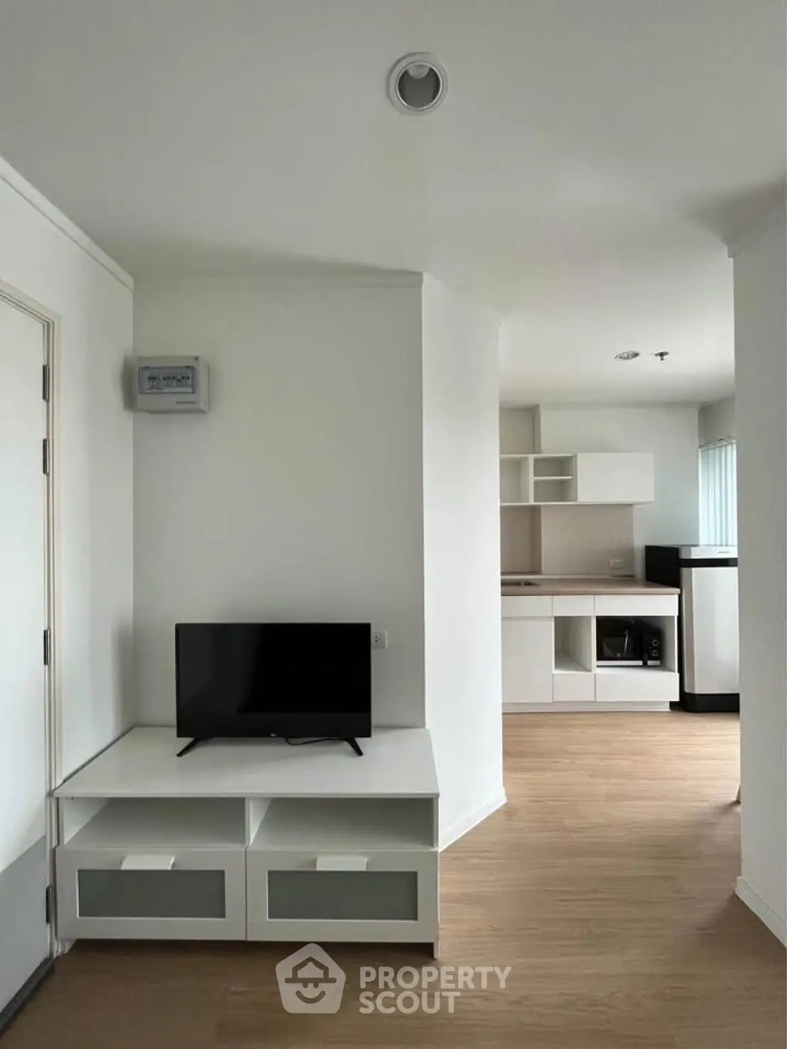 Modern apartment interior with sleek kitchen and cozy living area, perfect for urban living.