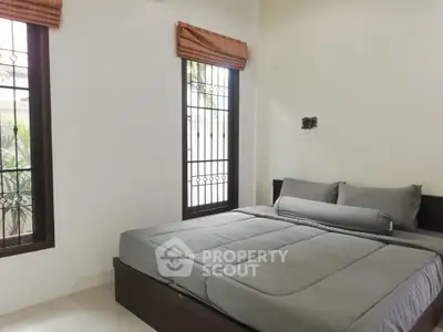 Cozy bedroom with large windows and modern decor